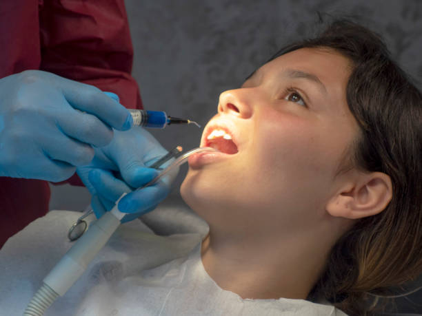 Operation with dental or dental hygienist patient. Woman with calculus or bruise. Oral Doctor wisdom tooth removal. Dentist. Expert business. -
